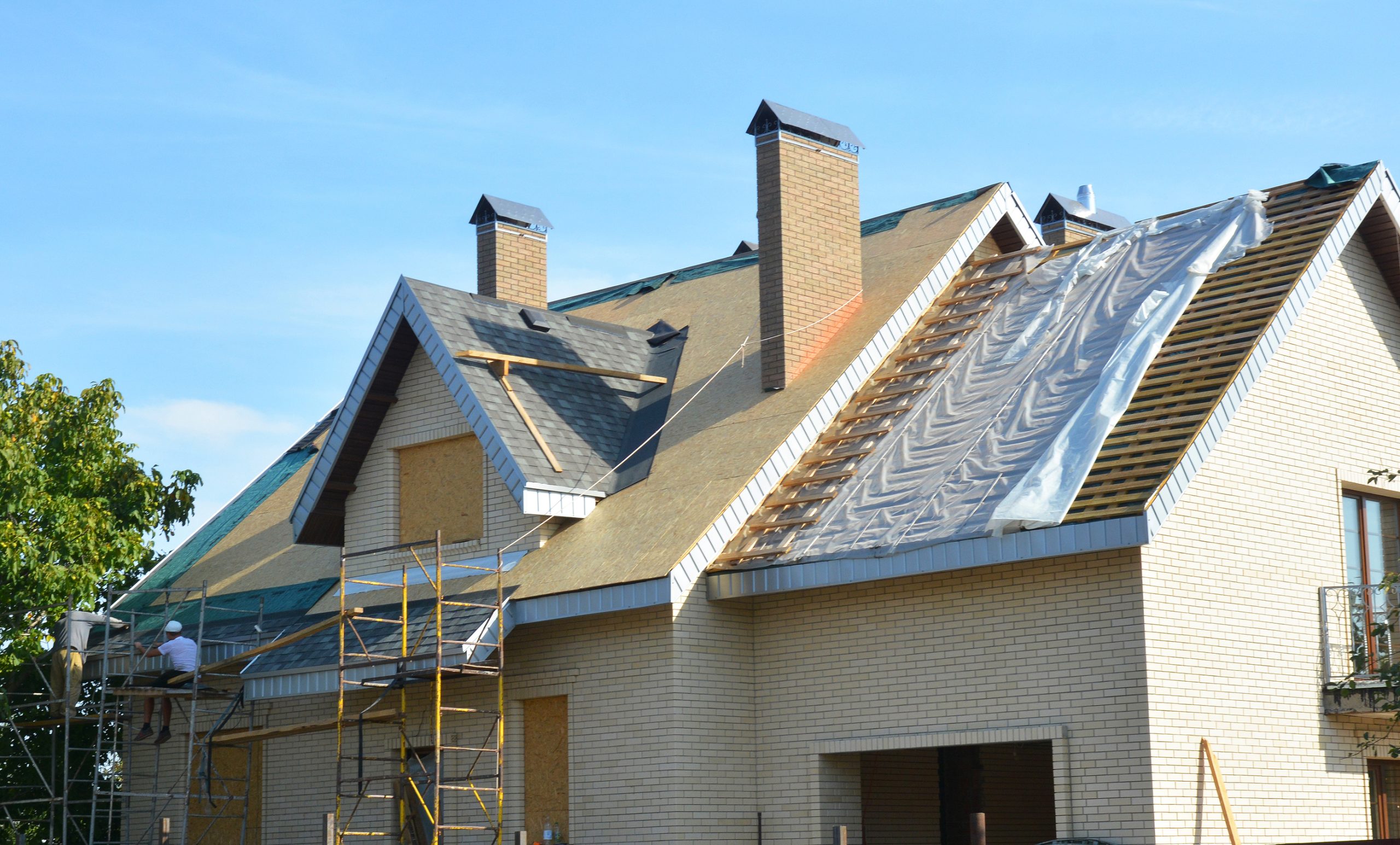 Roofing Contractors Installing House Roof Asphalt Shingles. Roof